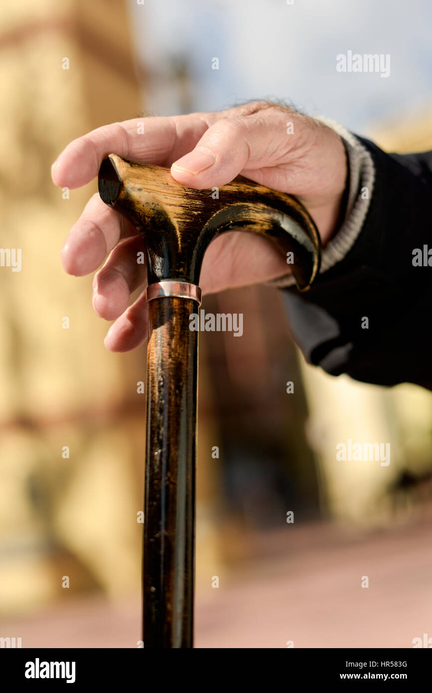 closeup of the hand of an old caucasian man clenching a walking stick Stock Photo