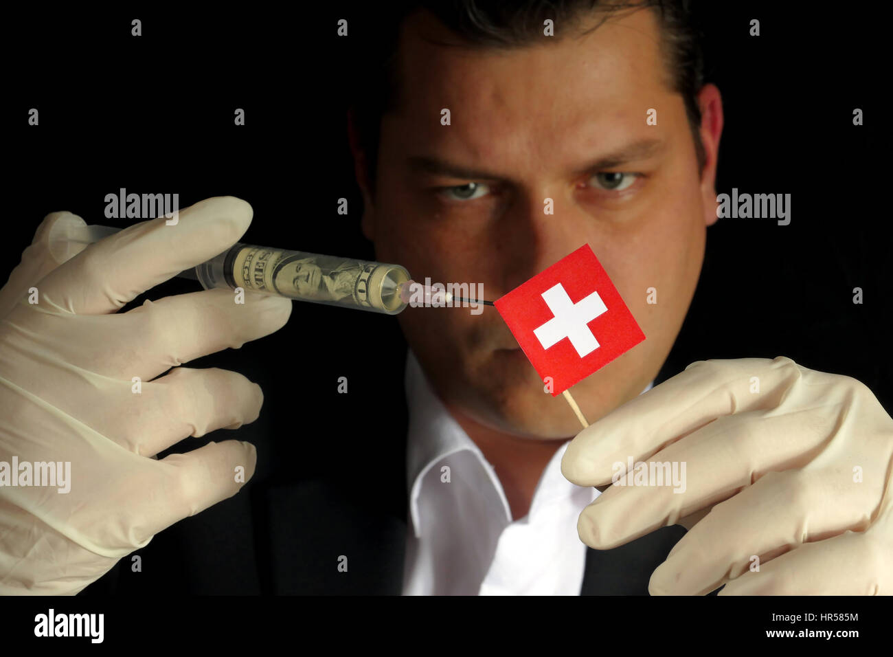 Fiscal Injection Young businessman gives a financial injection to Swiss flag isolated on ...