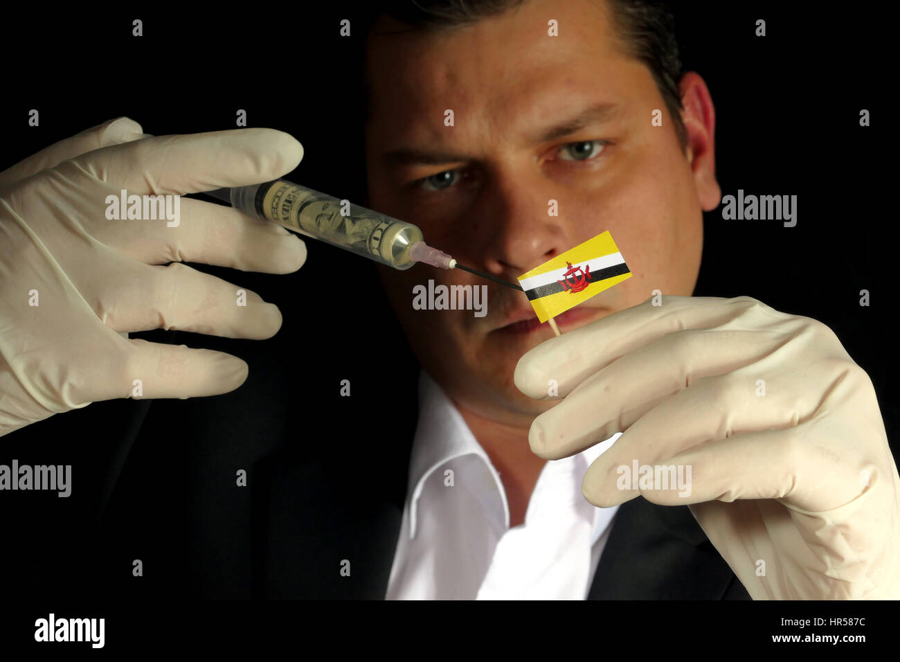 Fiscal Injection Young businessman gives a financial injection to Brunei flag isolated ...