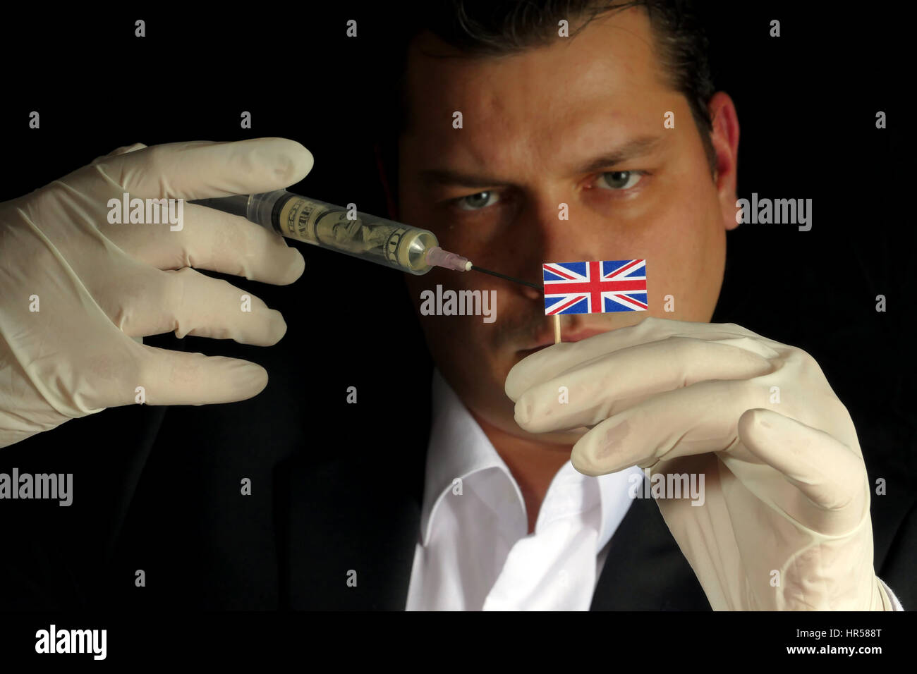 Fiscal Injection Young businessman gives a financial injection to United Kingdom flag ...