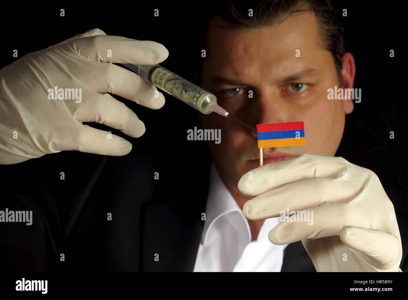 Fiscal Injection Young businessman gives a financial injection to Armenian flag isolated ...