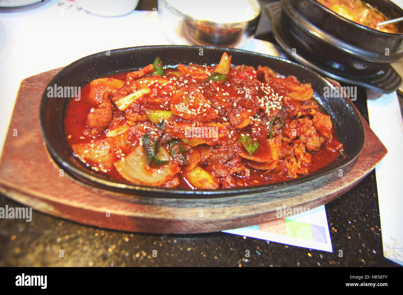 A portion of Stir Fried Pork on hotplate Stock Photo