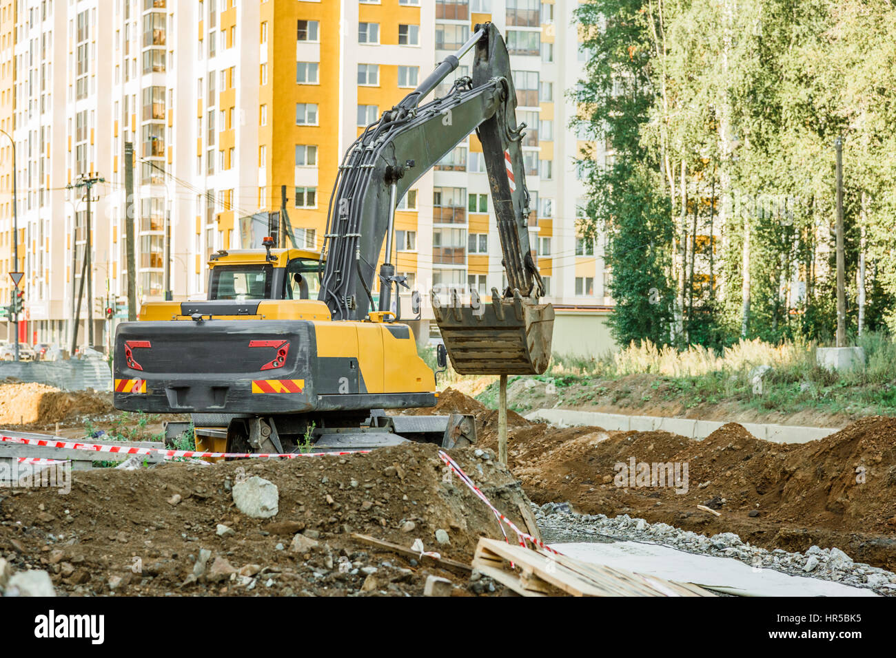 Excavator working outside on road construction in summer Stock Photo ...
