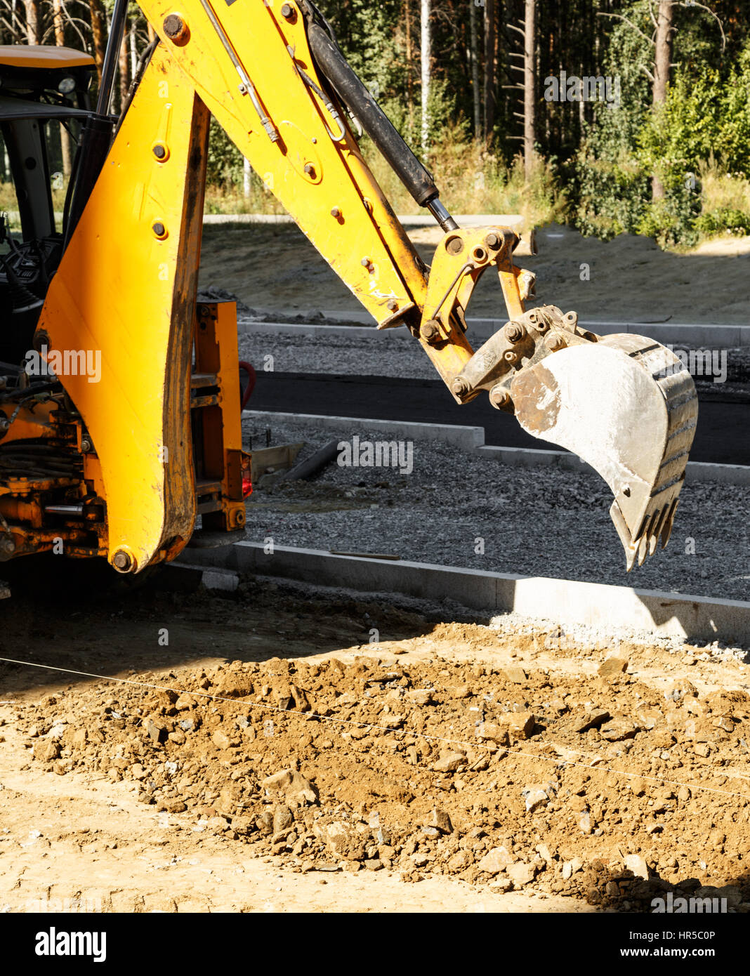 Excavator working outside on road construction in summer Stock Photo ...
