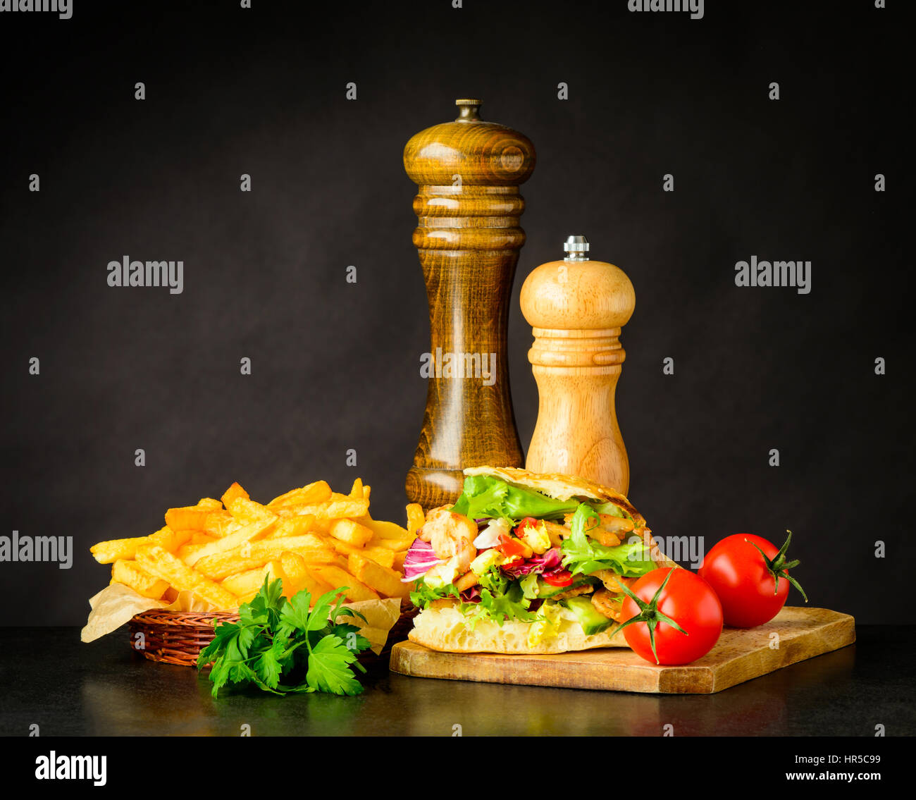 Doner Kebap Sandwich with French Fries and Fresh Vegetables Stock Photo