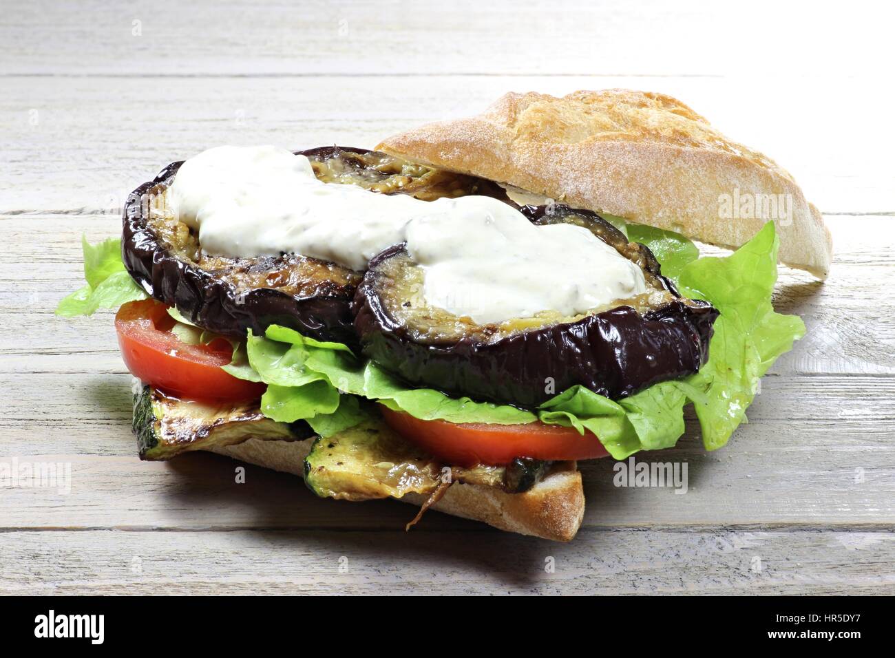 appetizing roll with grilled vegetables on wooden background Stock Photo