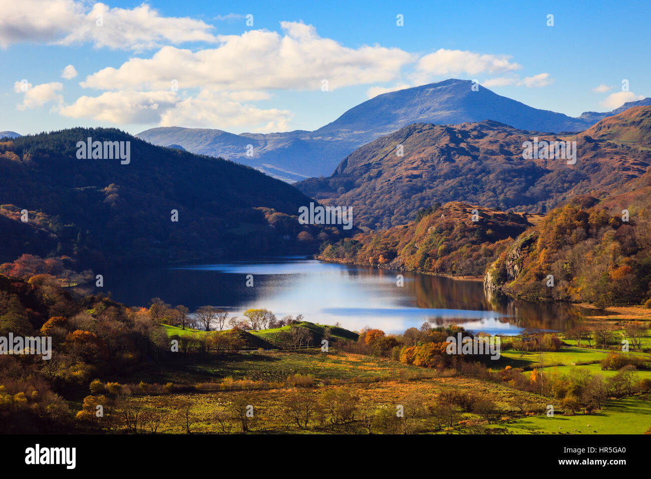 View along valley to Llyn Gwynant lake and Yr Aran in mountains of Snowdonia National Park in autumn. Nant Gwynant, Gwynedd, North Wales, UK, Britain Stock Photo