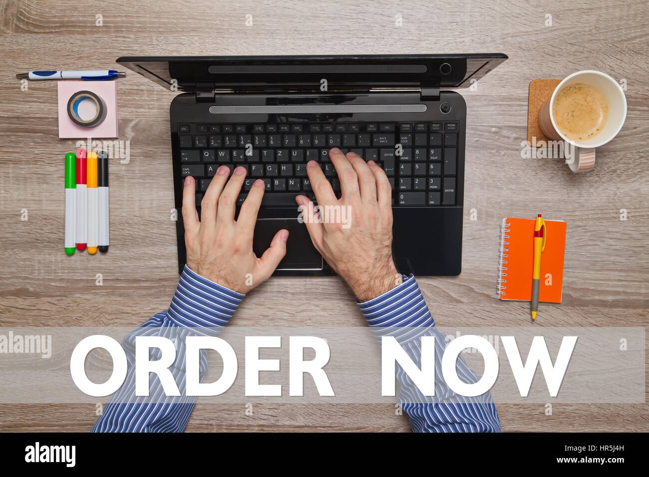 Male hand typing on laptop, message ORDER NOW Stock Photo