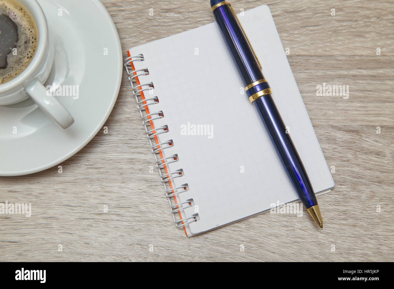 Desktop from above. Office space with an empty note book at coffee time looking for inspirational ideas Stock Photo
