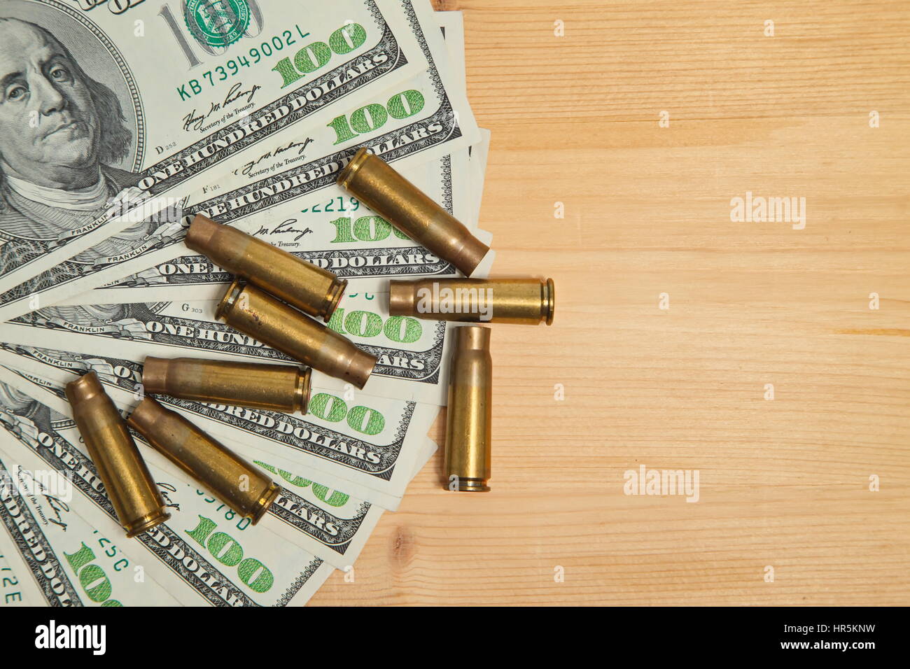The used bullet shells and dollars Stock Photo