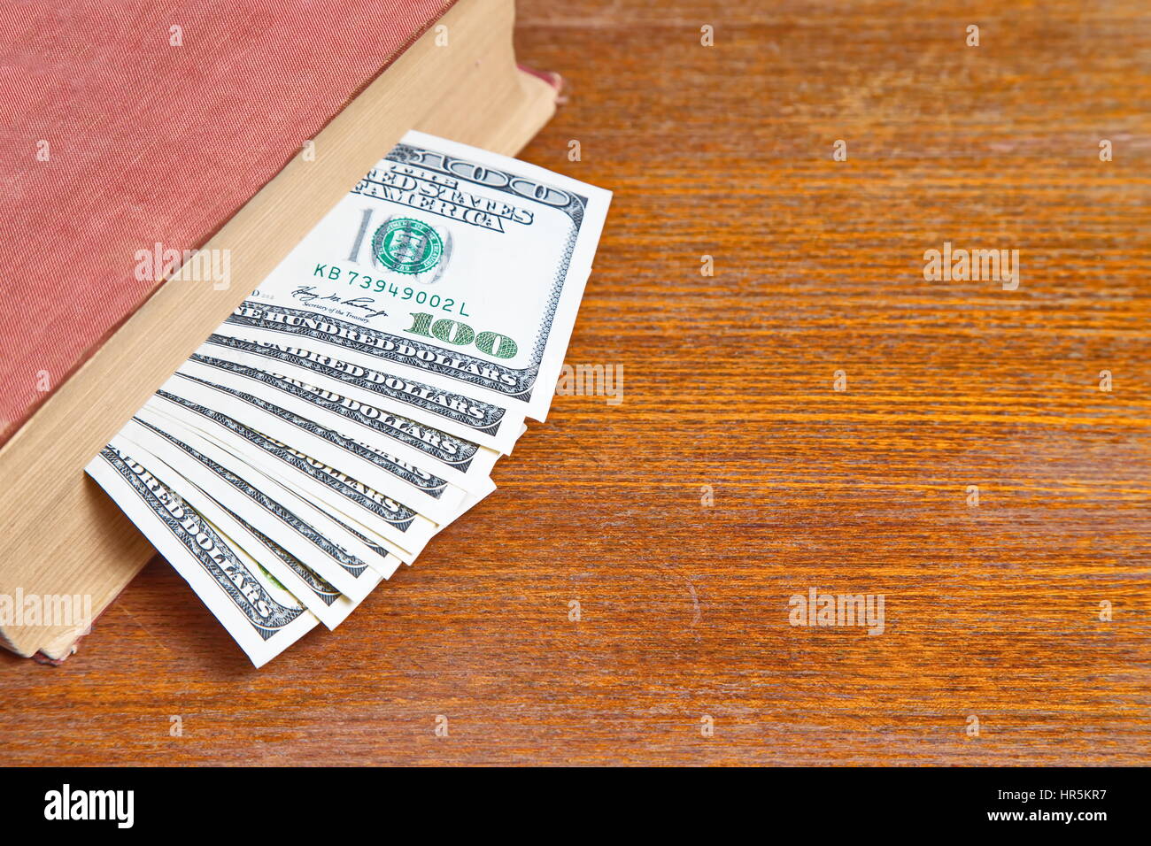 Hundred dollar bills in book Stock Photo