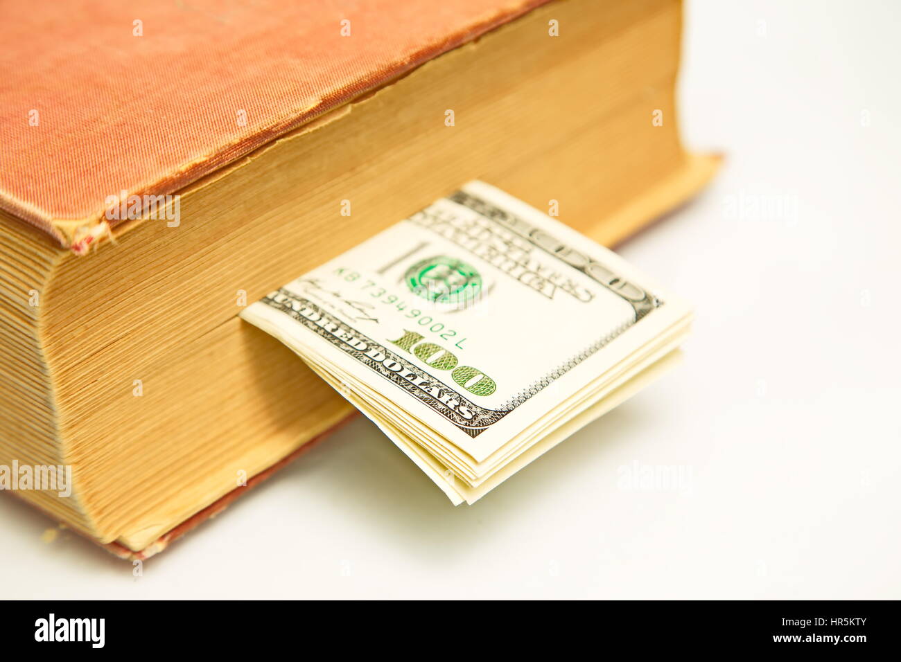 Hundred dollar bills in book Stock Photo