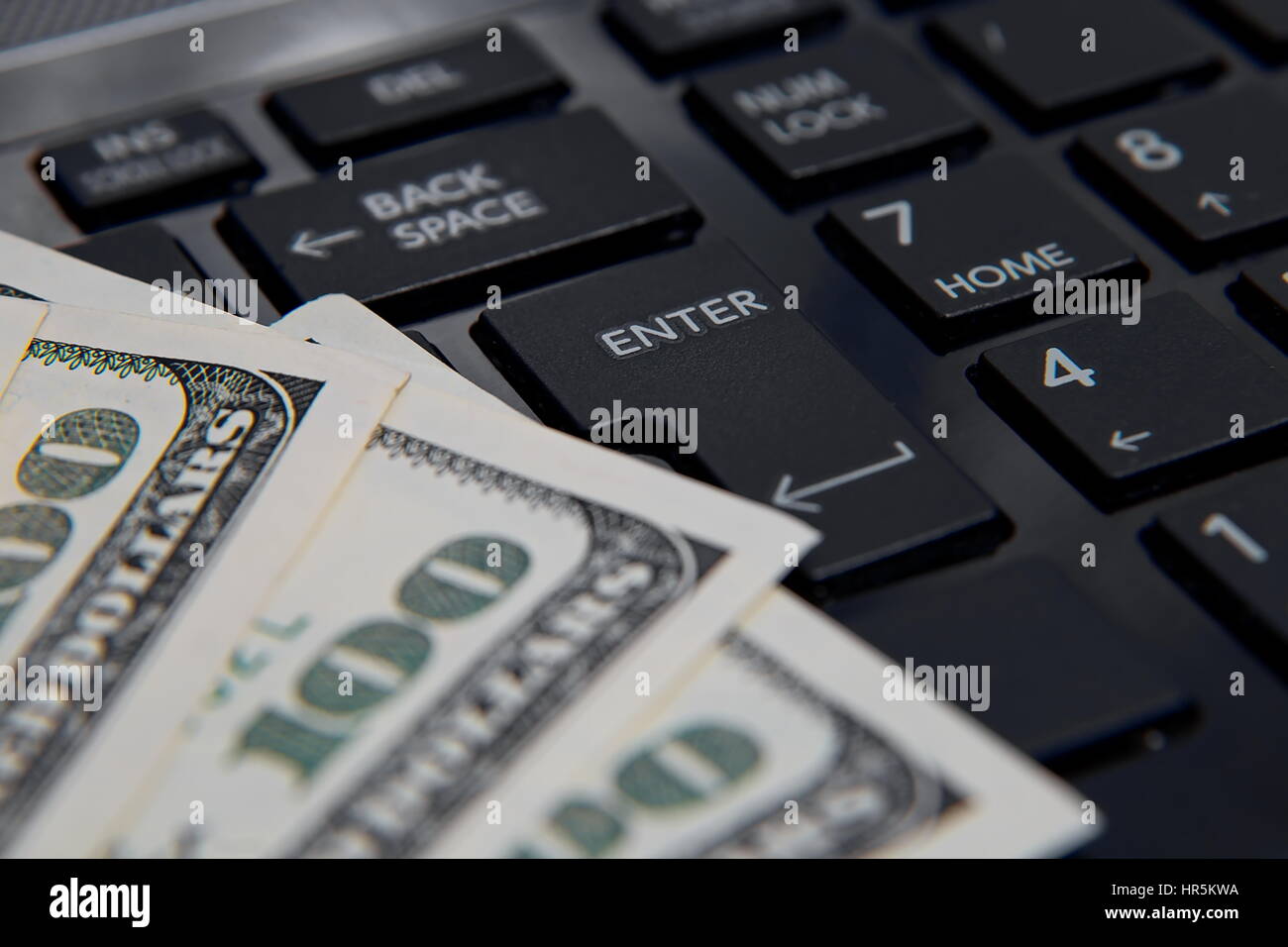 Money on computer keyboard Stock Photo