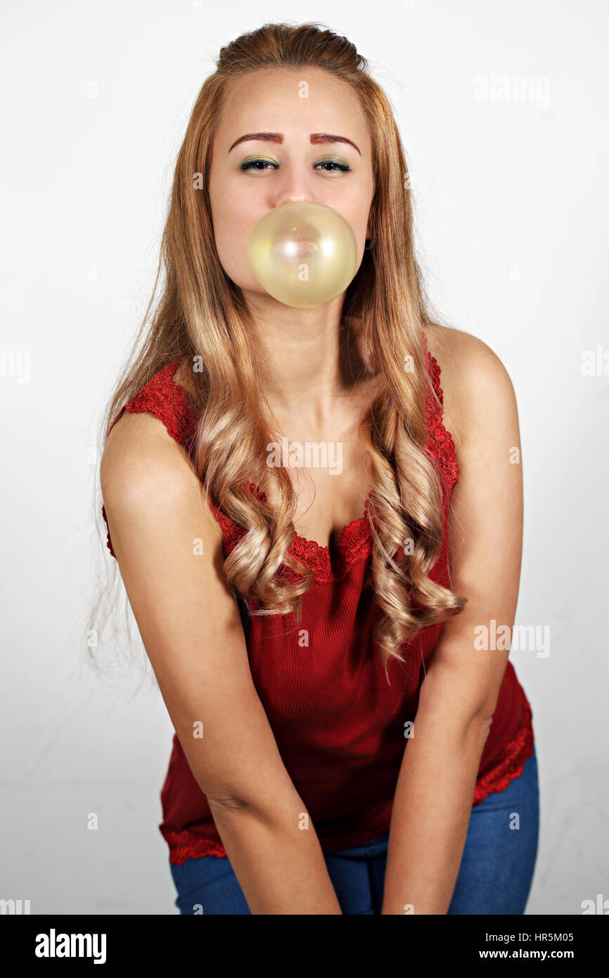 Young woman making a big bubble with a chewing gum Stock Photo