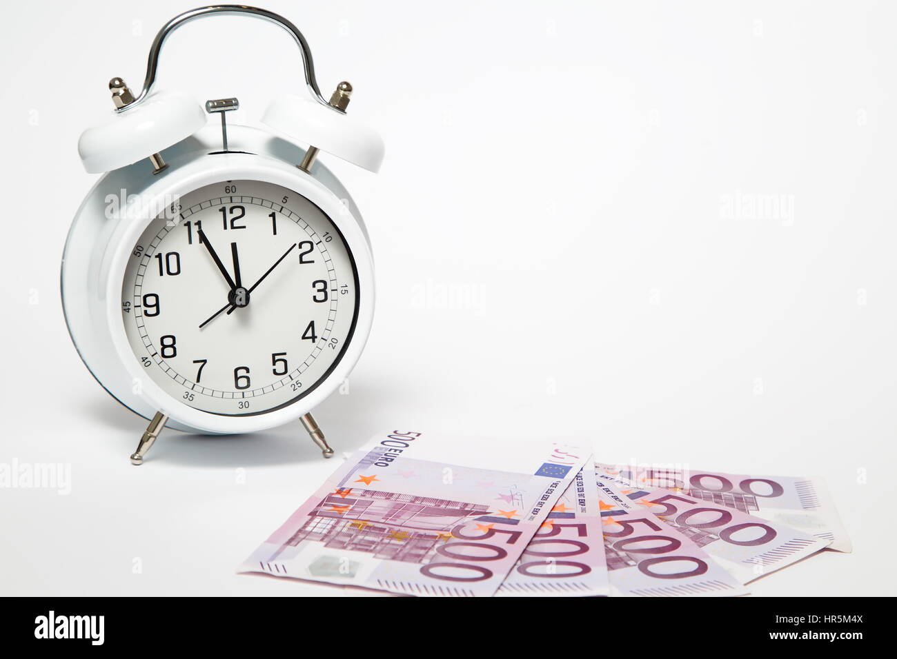 Old Clock and five hundred Euros, European bank withdraws five hundred banknotes. Stock Photo
