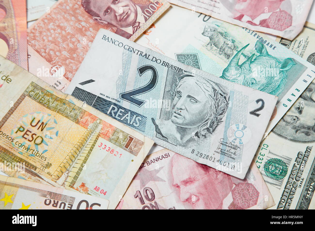 Background from paper money of the different countries. Brazilian real in the middle Stock Photo