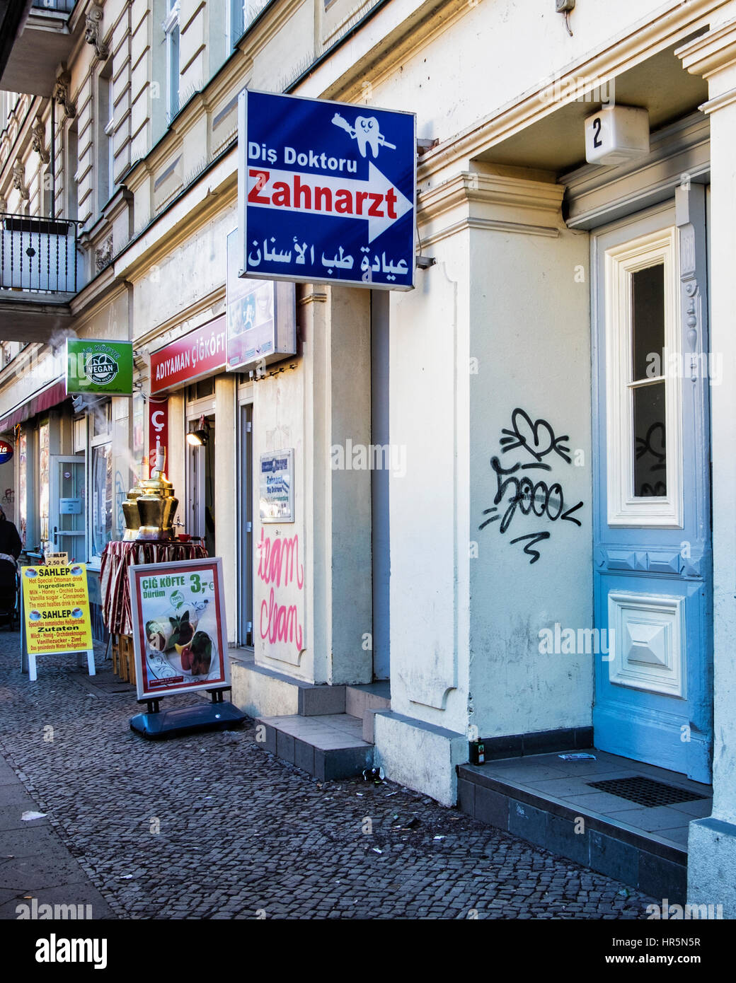 Berlin Kreuzberg. Dentist practice sign with German and Arabic lettering in Turkish Neighbourhood Stock Photo