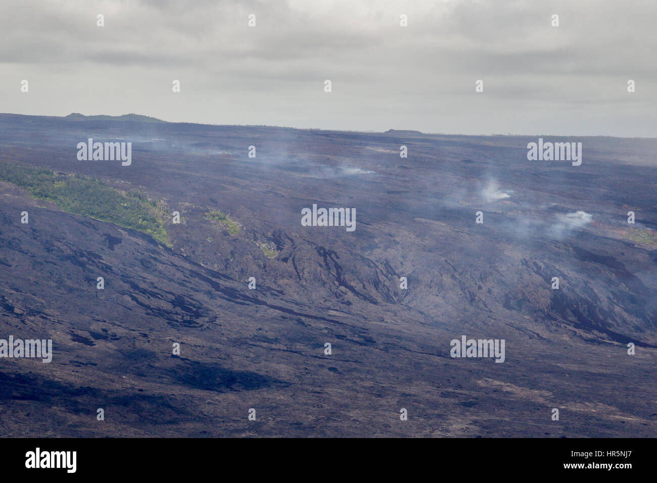 Aerial shot of volcanic fumes rising from the slopes of the active volcano Kilauea on Big Island, Hawaii, USA. Stock Photo