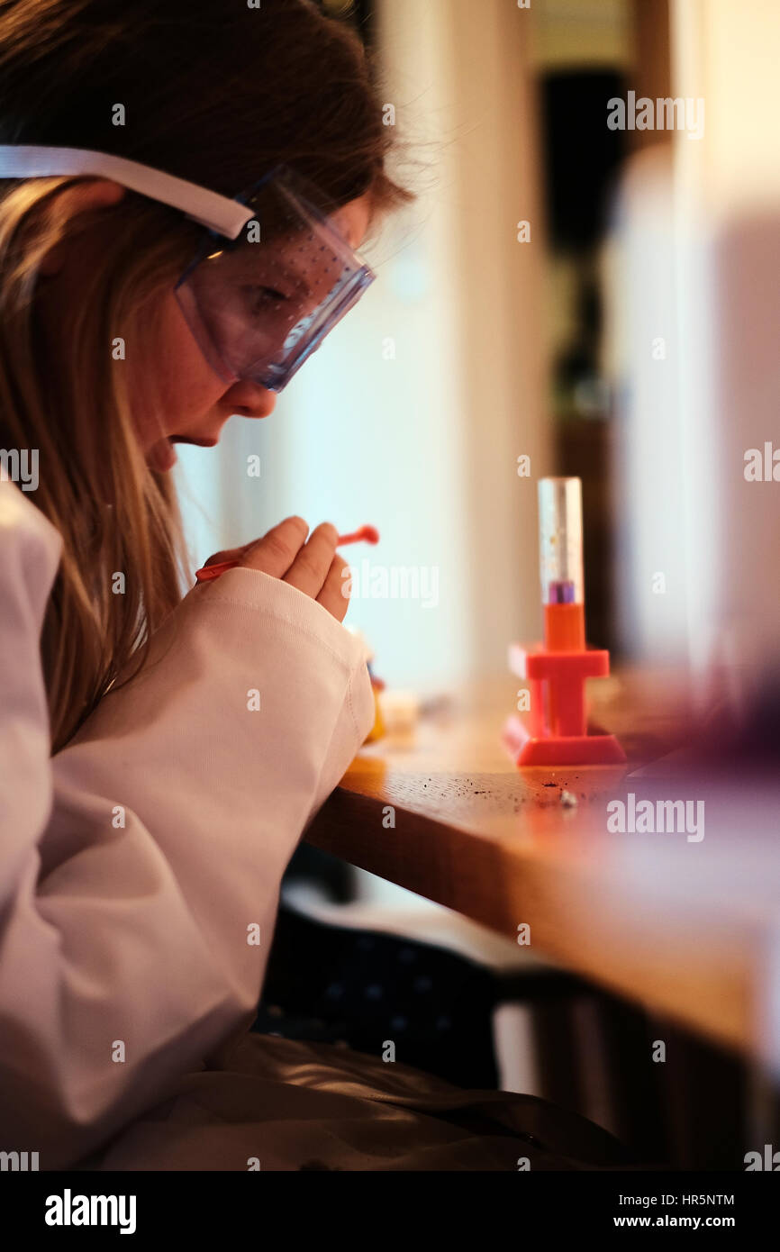 Young girl in white lab coat playing with chemistry science set Stock ...