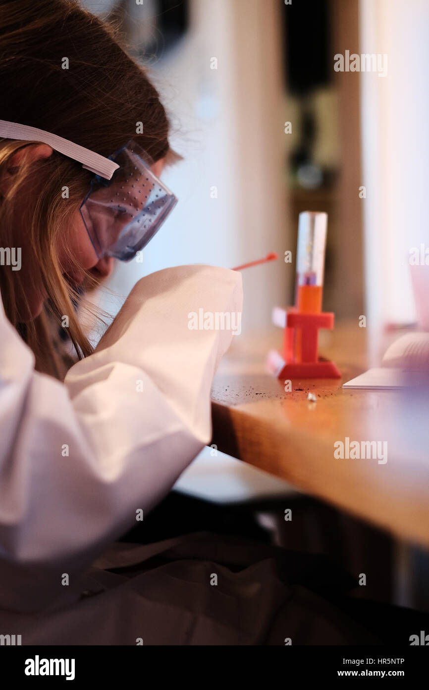 Young girl in white lab coat playing with chemistry science set Stock ...