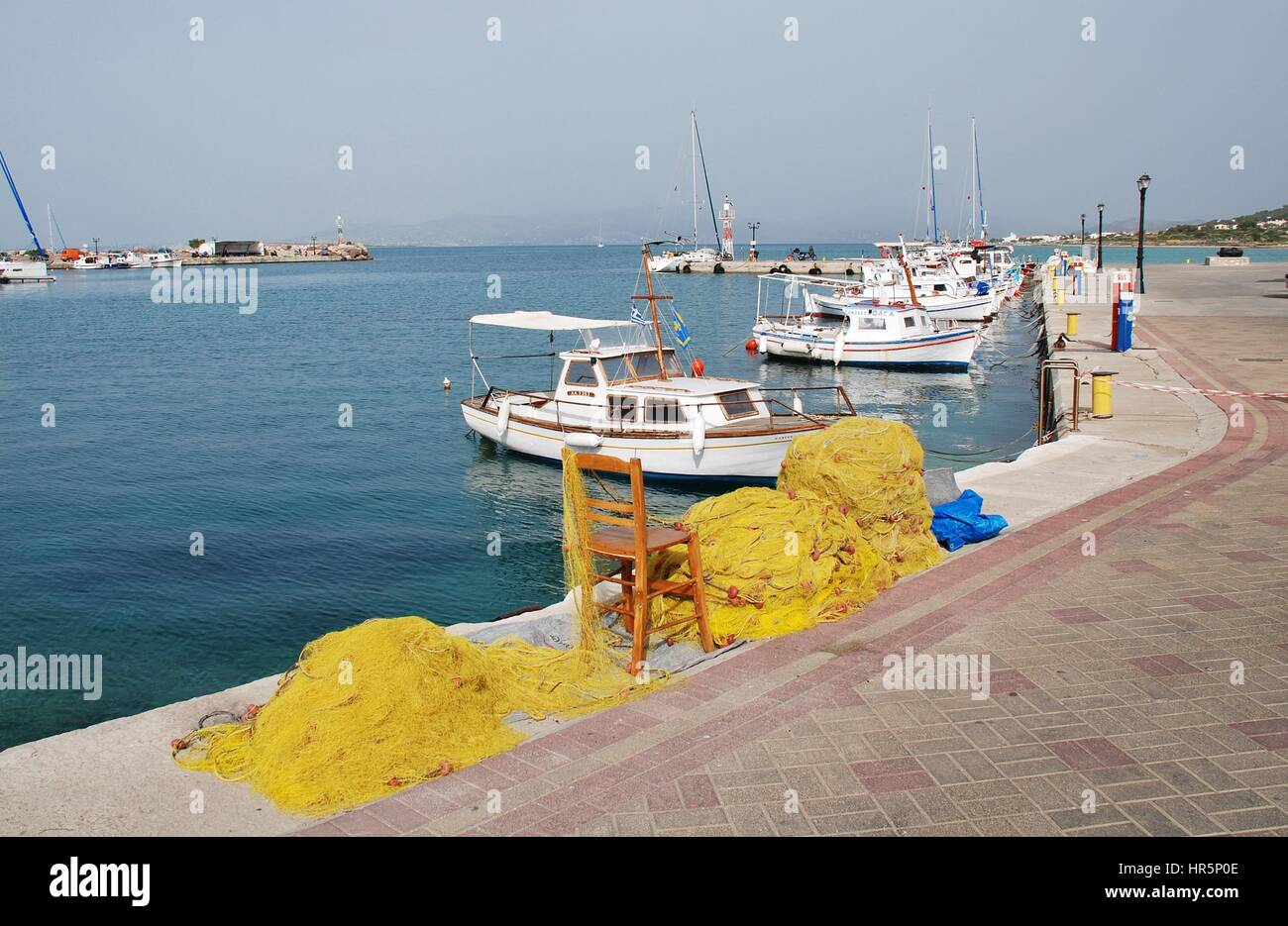 Small boats moored at Milos harbour on the Greek island of Agistri on May 12, 2016. Under an hour from Piraeus, the island is popular with Athenians. Stock Photo