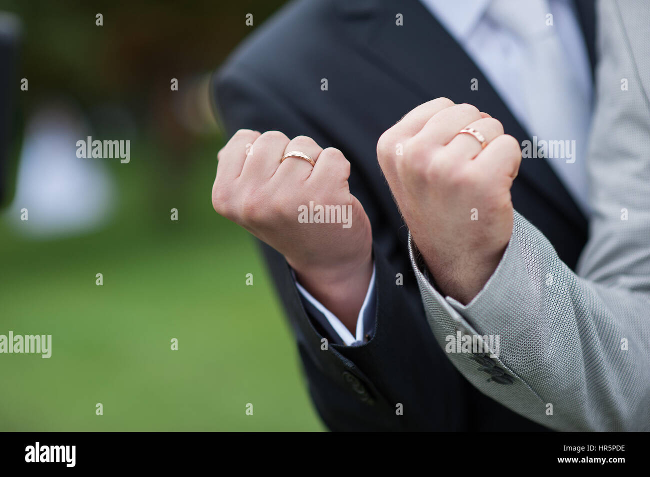 two male fist with wedding gold rings. Stock Photo