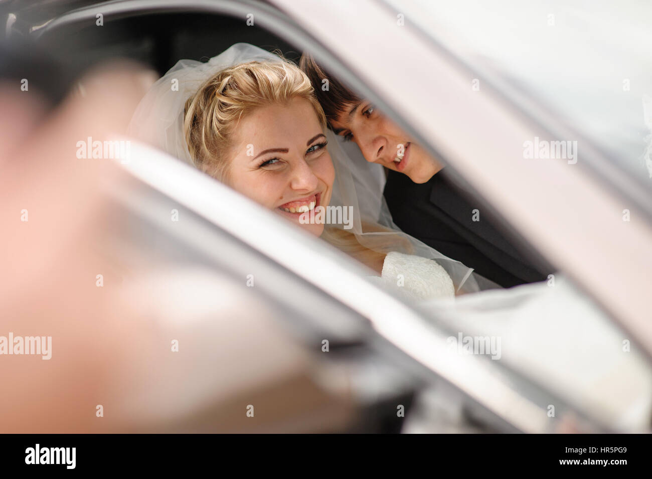 happy bride and groom in the wedding car Stock Photo - Alamy