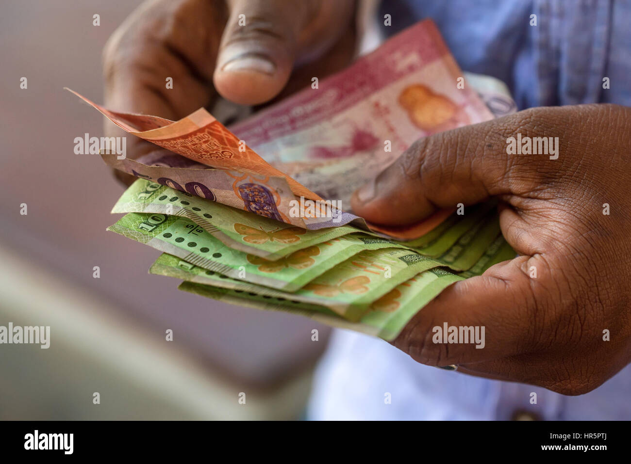 Closeup photograph of hands counting srilankan rupies Stock Photo - Alamy