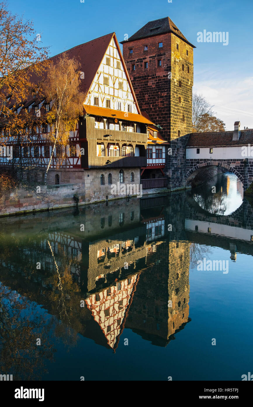 15th century Weinstadle timbered building and Henkersteg or Hangman's Bridge reflected in Pegnitz River.  Nuremberg, Bavaria, Germany Stock Photo