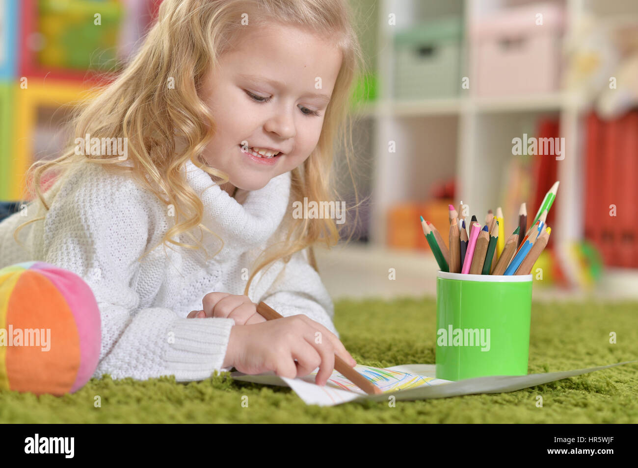 cute little girl drawing, lying on the floor Stock Photo - Alamy