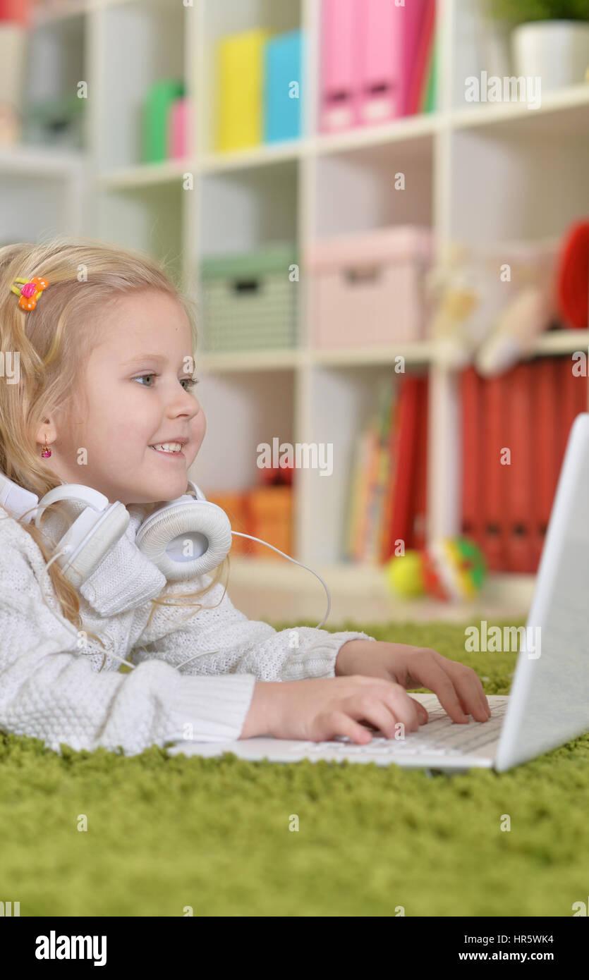 Portrait of a cute little girl using laptop Stock Photo - Alamy
