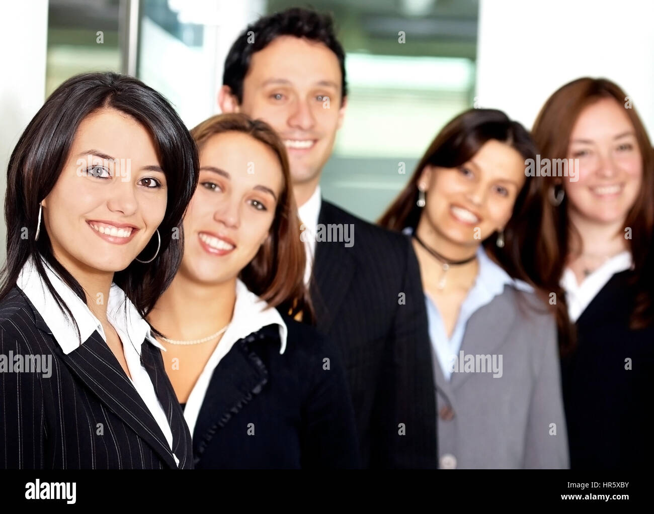 Business team in an office with a businesswoman leading Stock Photo - Alamy