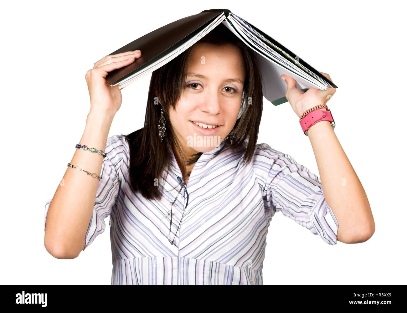 female student with book on head over white Stock Photo - Alamy