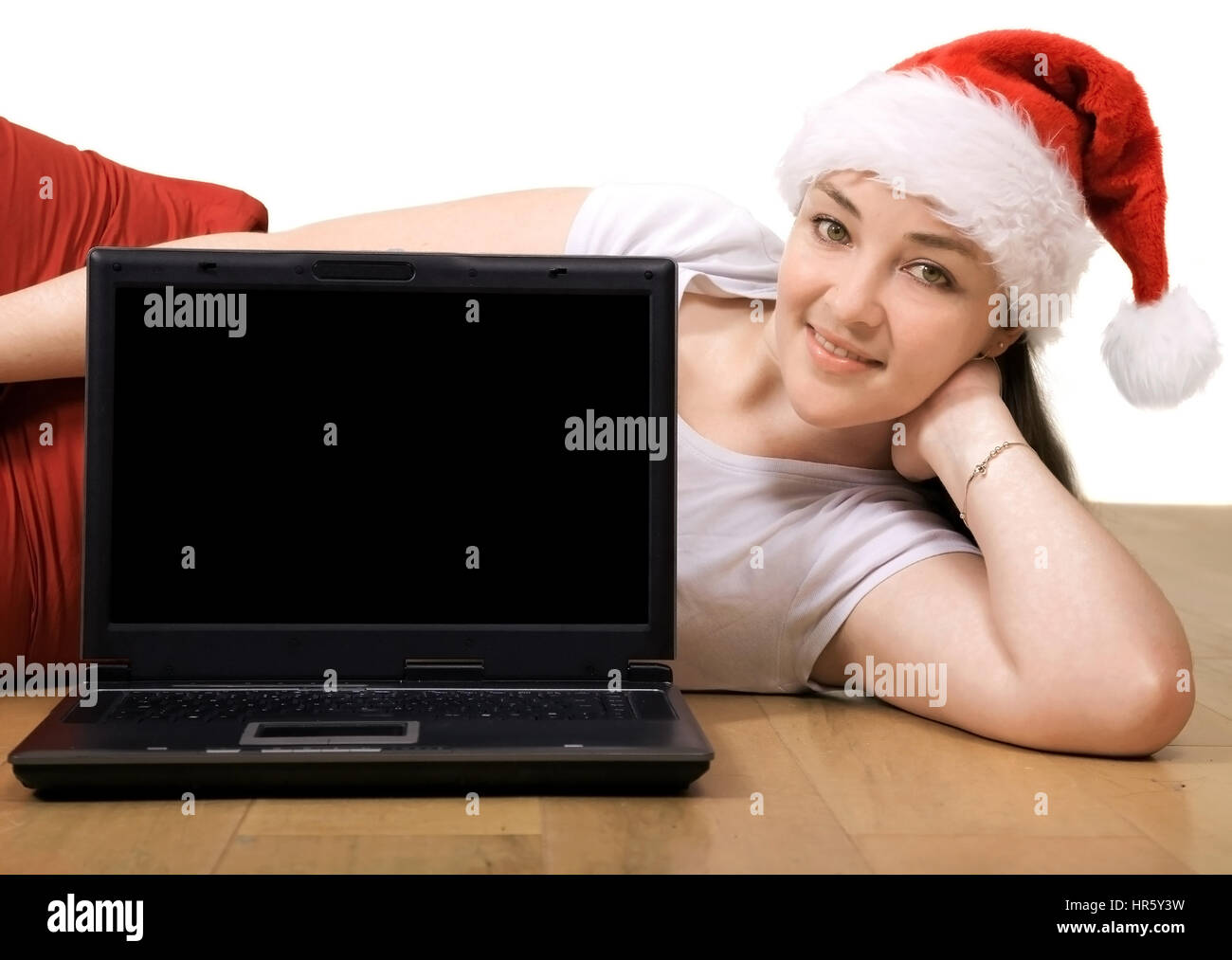 Beautiful girl with a laptop lying on the floor Stock Photo