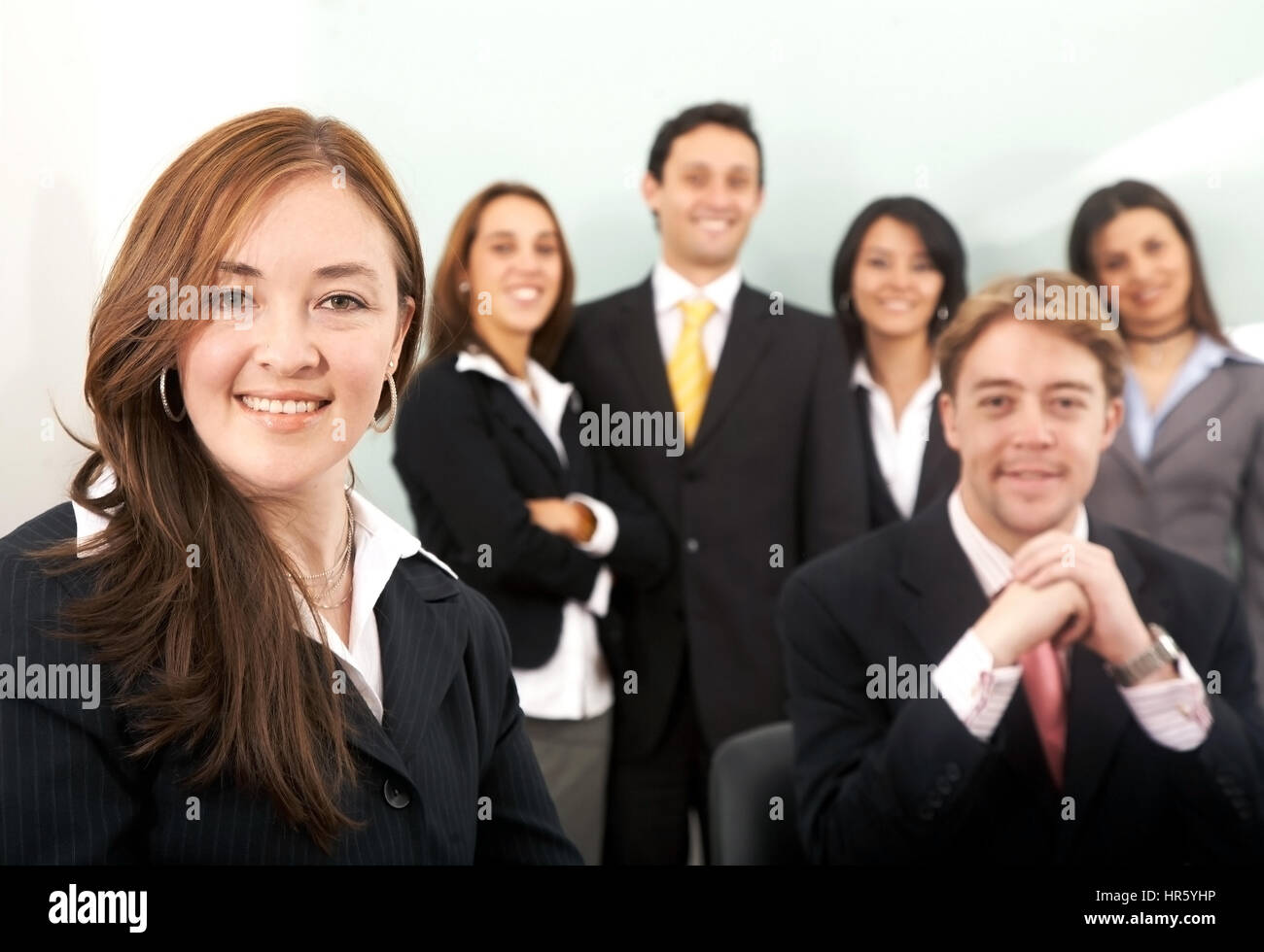 Business team in an office with a businesswoman leading Stock Photo - Alamy