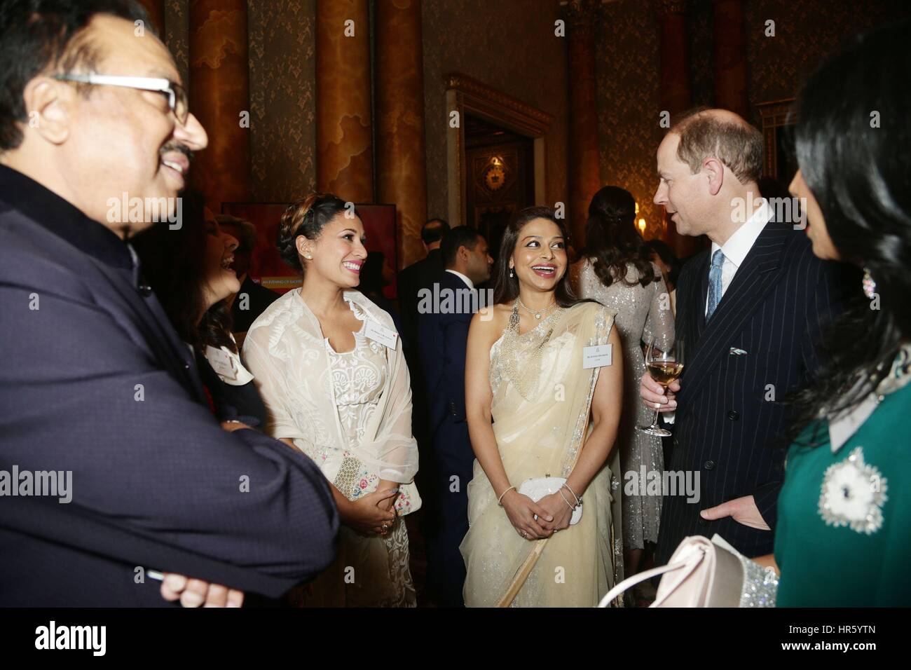 The Earl of Wesses (left) speaks to Ayesha Dharker (centre) during a reception to mark the launch of the UK-India Year of Culture 2017 at Buckingham Palace, London. Stock Photo