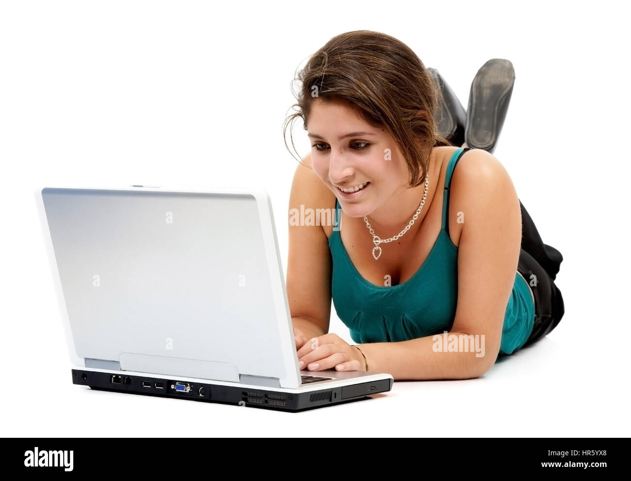 woman working on a laptop computer on the floor isolated over a white ...