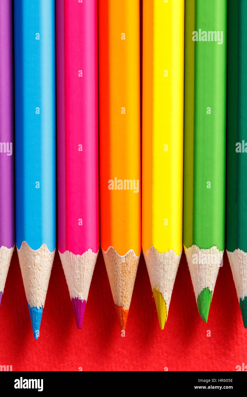coloring pencils on a red background Stock Photo Alamy