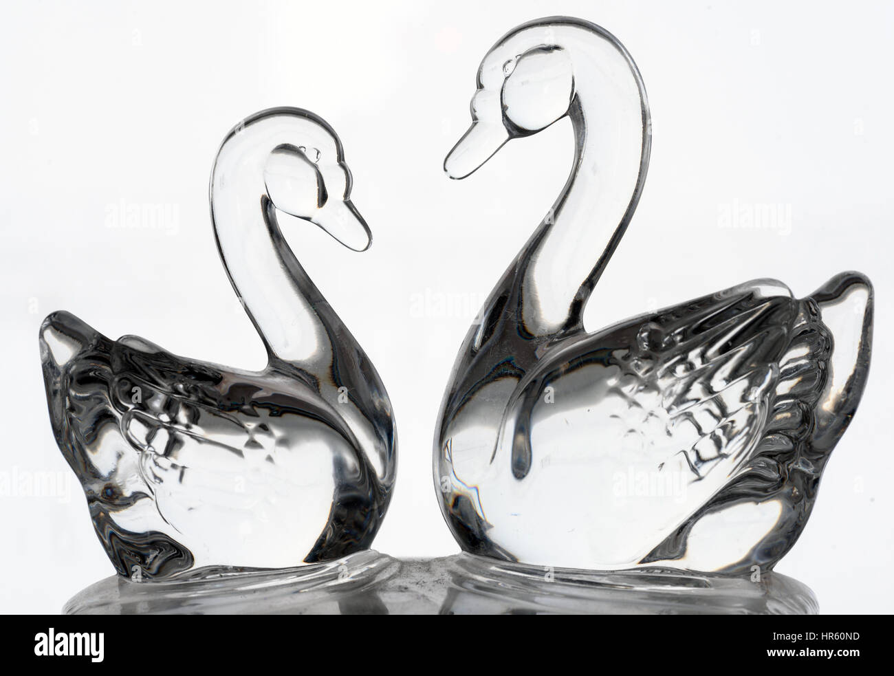 Two ornamental glass swans set against a white background Stock Photo