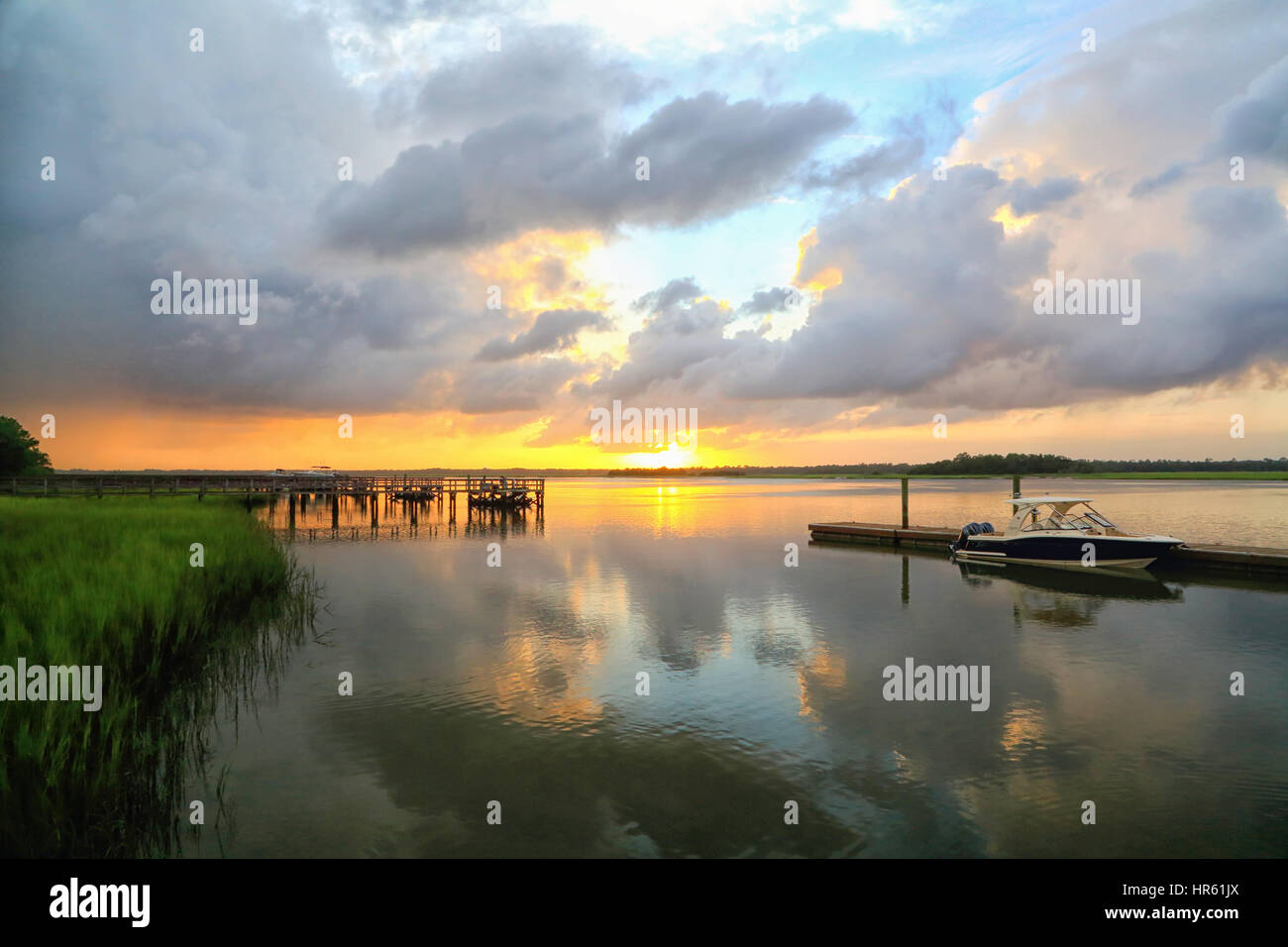 A dramatic sunset through storm clouds over the Kiawah River on Kiawah Island, South Carolina. Stock Photo