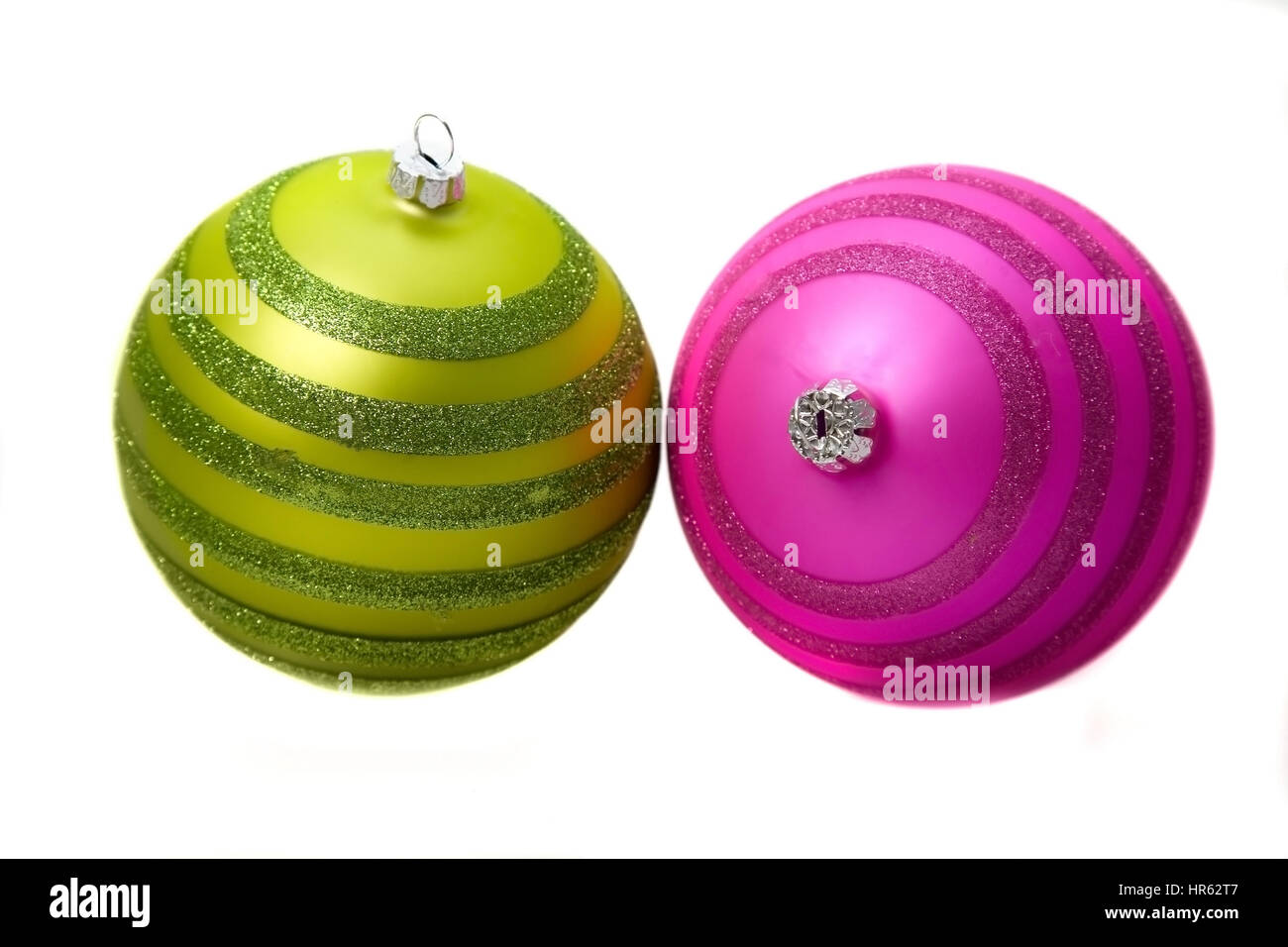 pair of christmas baubles in attractive colours over a white background
