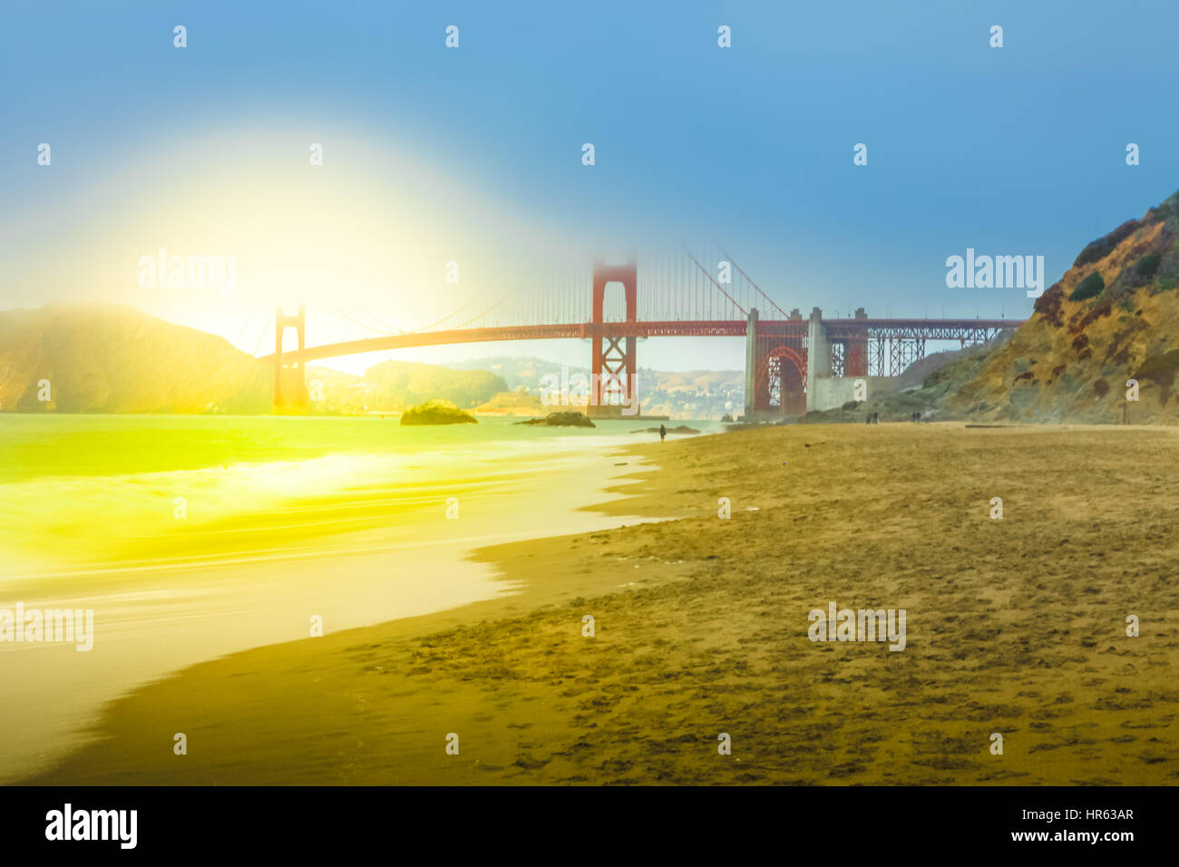 Spectacular view of Golden Gate Bridge from Baker Beach at sunset on