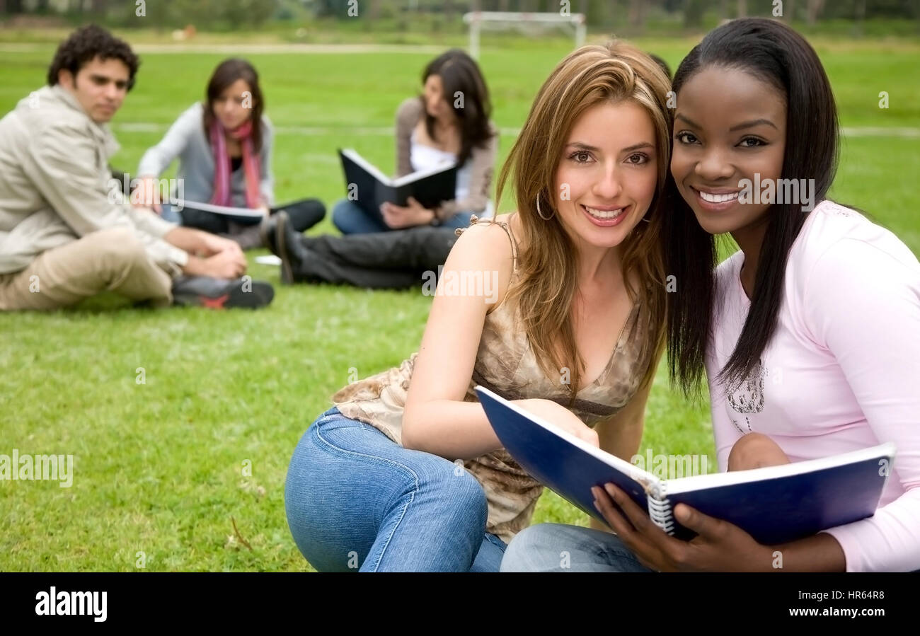 college students smiling outdoors looking very happy Stock Photo