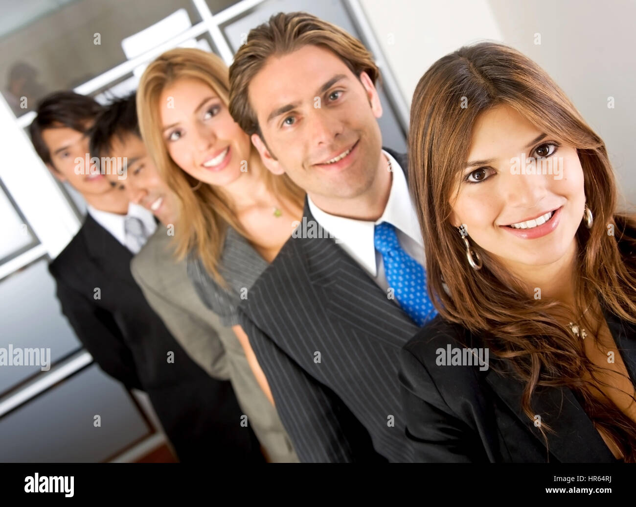 business team in an office smiling - diversity Stock Photo - Alamy