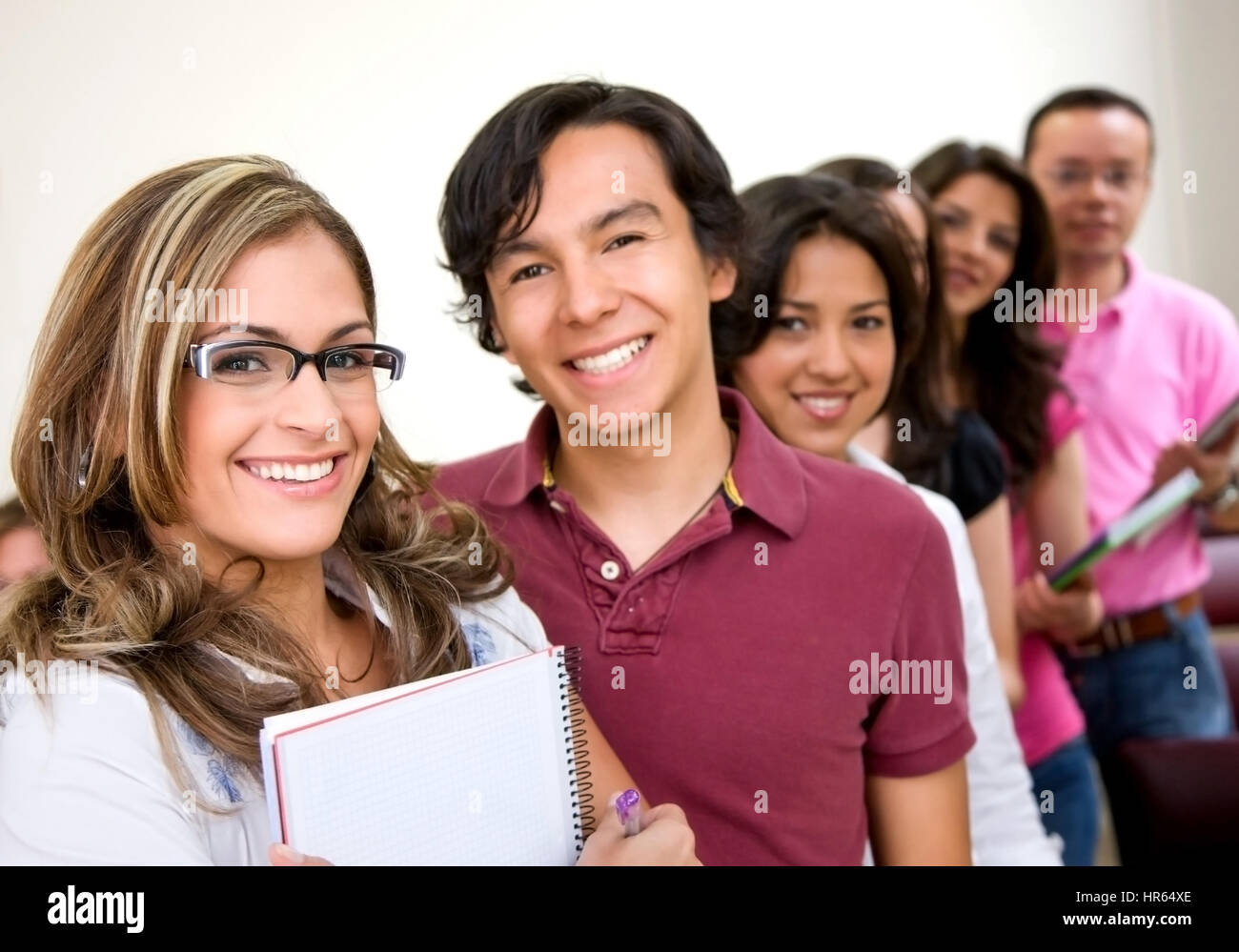 teacher and university students smiling in a classroom Stock Photo - Alamy