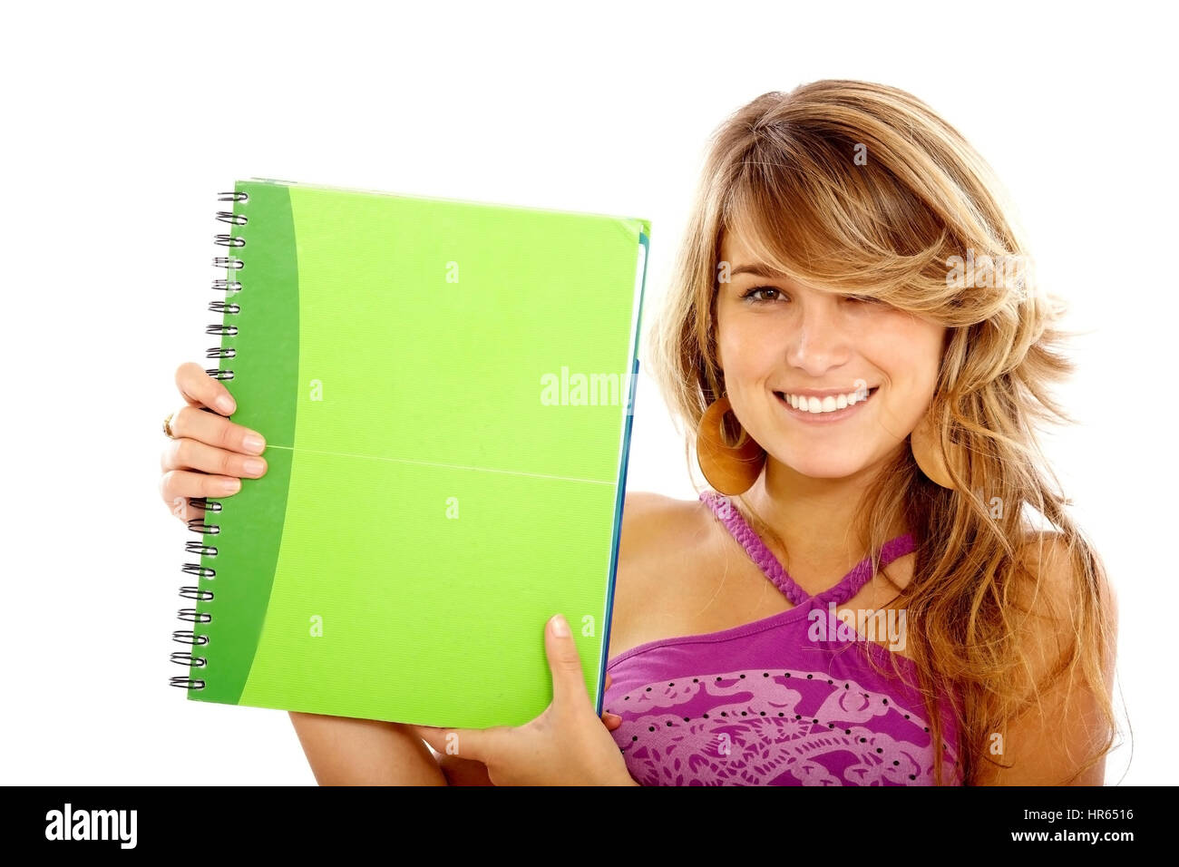 casual female student smiling and holding a notebook - isolated over a ...