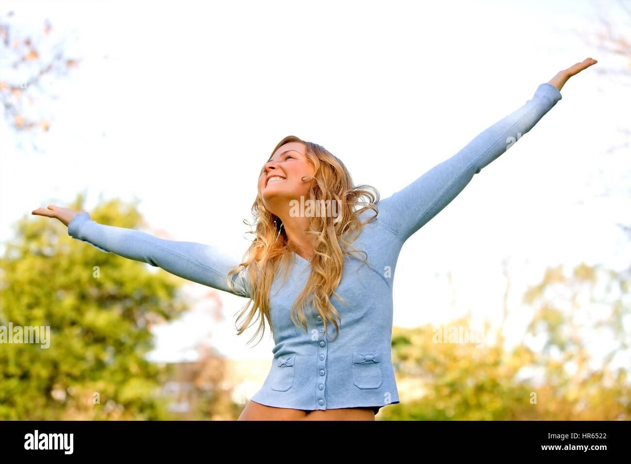 freedom woman smiling outdoors in a park with arms open Stock Photo - Alamy