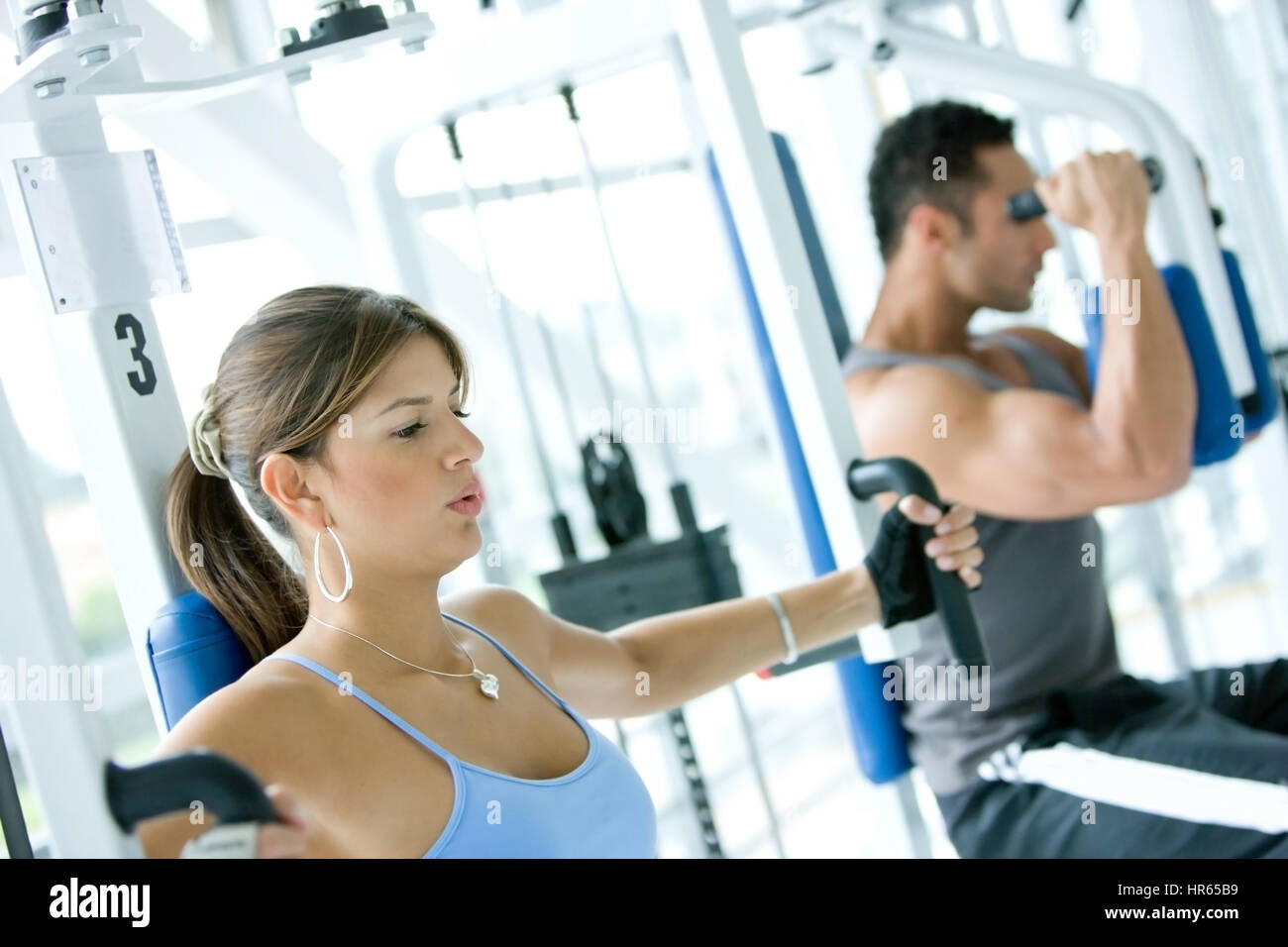 man and woman doing exercises in the gym Stock Photo - Alamy
