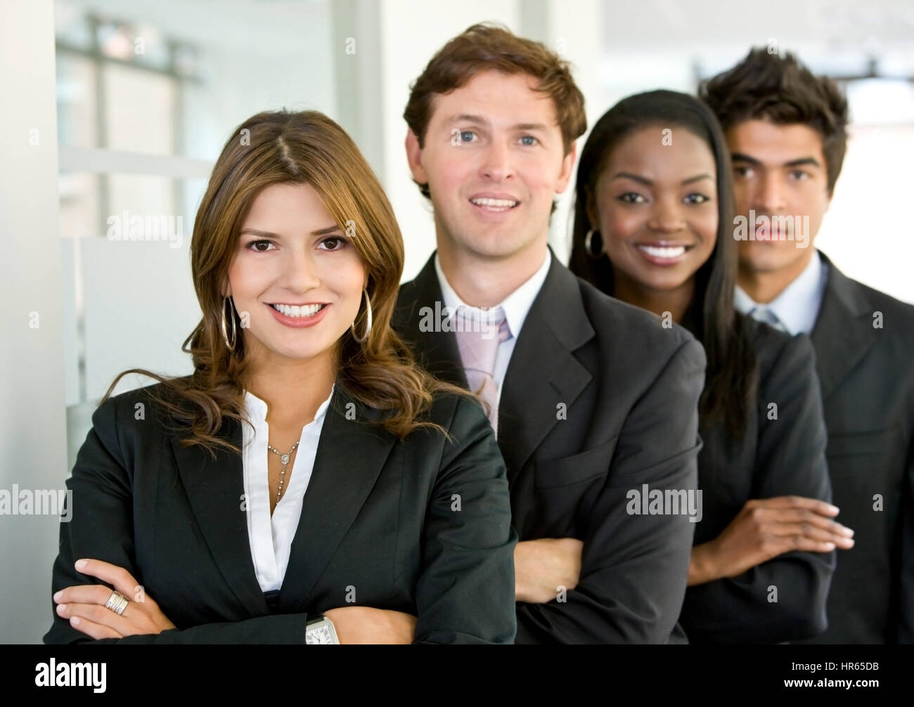 group of business colleagues smiling in an office lined up Stock Photo ...