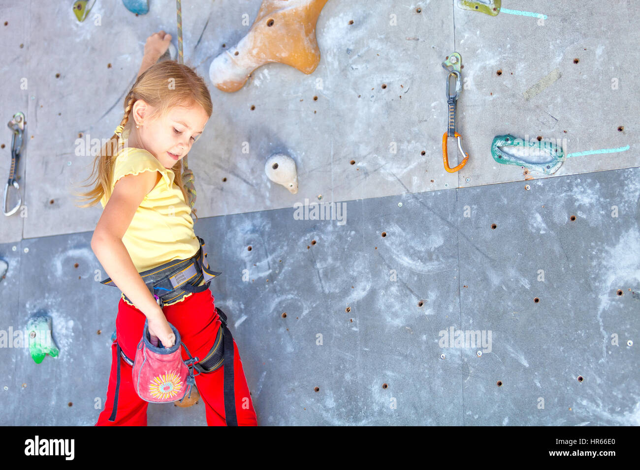 little girl climbing a rock wall indoor Stock Photo Alamy